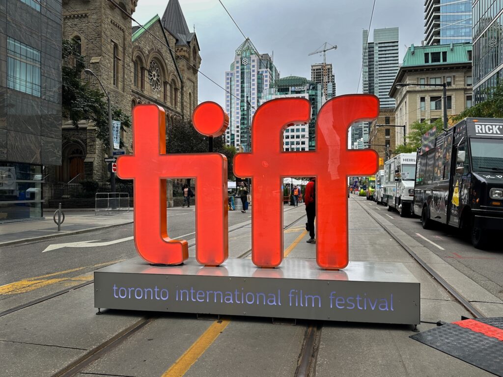 Toronto, Canada - September 9, 2023: A large backlit “tiff” sign signals the entrance to the pedestrian only street festival in honour of the Toronto International Film Festival. 
