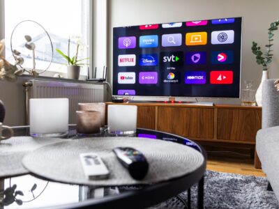Remote controls in front of a tv screen in a home.