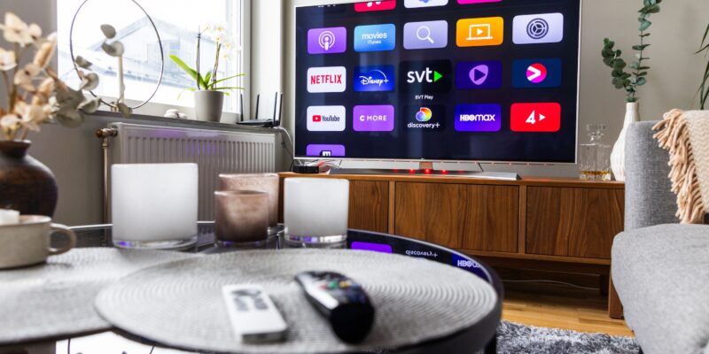 Remote controls in front of a tv screen in a home.