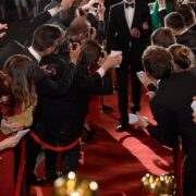 celebrity on the red carpet. man and woman in evening dresses among photographers and fans on the red carpet