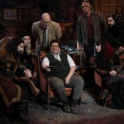 “WHAT WE DO IN THE SHADOWS” -- “The Finale” -- Season 6, Episode 11 (Airs Dec 16) — Pictured (L-R): Kayvan Novak as Nandor, Kristen Schaal as The Guide, Mark Proksch as Colin Robinson, Harvey Guillén as Guillermo, Andy Assaf as Monster, Natasia Demetriou as Nadja, Matt Berry as Laszlo. CR: Russ Martin/FX