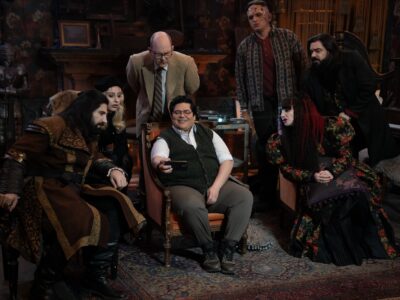 “WHAT WE DO IN THE SHADOWS” -- “The Finale” -- Season 6, Episode 11 (Airs Dec 16) — Pictured (L-R): Kayvan Novak as Nandor, Kristen Schaal as The Guide, Mark Proksch as Colin Robinson, Harvey Guillén as Guillermo, Andy Assaf as Monster, Natasia Demetriou as Nadja, Matt Berry as Laszlo. CR: Russ Martin/FX