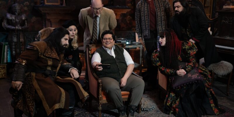 “WHAT WE DO IN THE SHADOWS” -- “The Finale” -- Season 6, Episode 11 (Airs Dec 16) — Pictured (L-R): Kayvan Novak as Nandor, Kristen Schaal as The Guide, Mark Proksch as Colin Robinson, Harvey Guillén as Guillermo, Andy Assaf as Monster, Natasia Demetriou as Nadja, Matt Berry as Laszlo. CR: Russ Martin/FX
