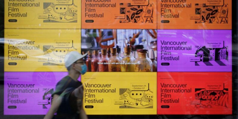 Vancouver, Canada. 25th Sep, 2020. A man walks past a digital billboard about the 39th Vancouver International Film Festival (VIFF) in Vancouver, British Columbia, Canada, Sept. 25, 2020. Featuring more than 100 films and events, the 39th VIFF is held from Sept. 24 till Oct. 7.
