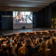 Jyvaskyla, Finland - August 27, 2019: Cinema picnic in Lounaispuisto park. Free entrance event. People watching “Shoplifters” - 2018 Japanese drama film that won Palme d'Or at Cannes Film Festival.