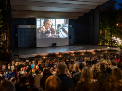 Jyvaskyla, Finland - August 27, 2019: Cinema picnic in Lounaispuisto park. Free entrance event. People watching “Shoplifters” - 2018 Japanese drama film that won Palme d'Or at Cannes Film Festival.
