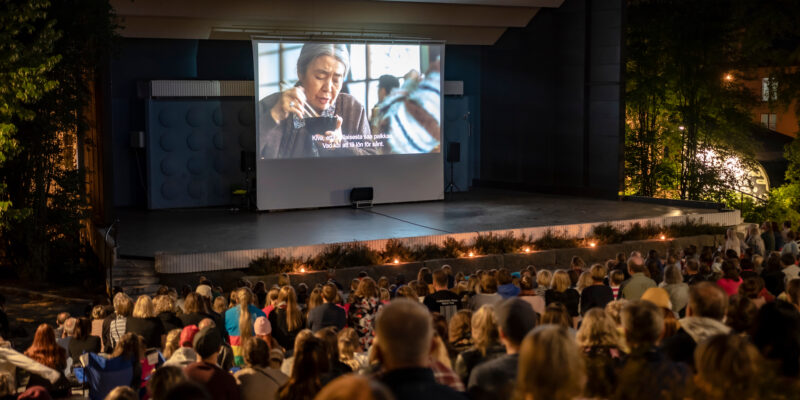 Jyvaskyla, Finland - August 27, 2019: Cinema picnic in Lounaispuisto park. Free entrance event. People watching “Shoplifters” - 2018 Japanese drama film that won Palme d'Or at Cannes Film Festival.