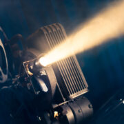 film projector on a wooden background with dramatic lighting and selective focus