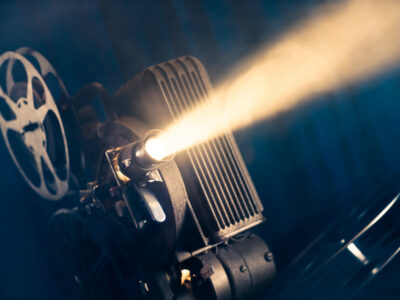 film projector on a wooden background with dramatic lighting and selective focus