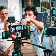 People learning how to use a movie camera during a cinematography workshop