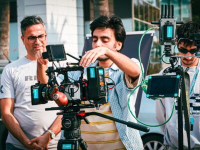 People learning how to use a movie camera during a cinematography workshop