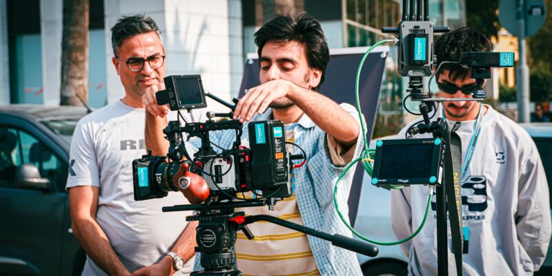 People learning how to use a movie camera during a cinematography workshop